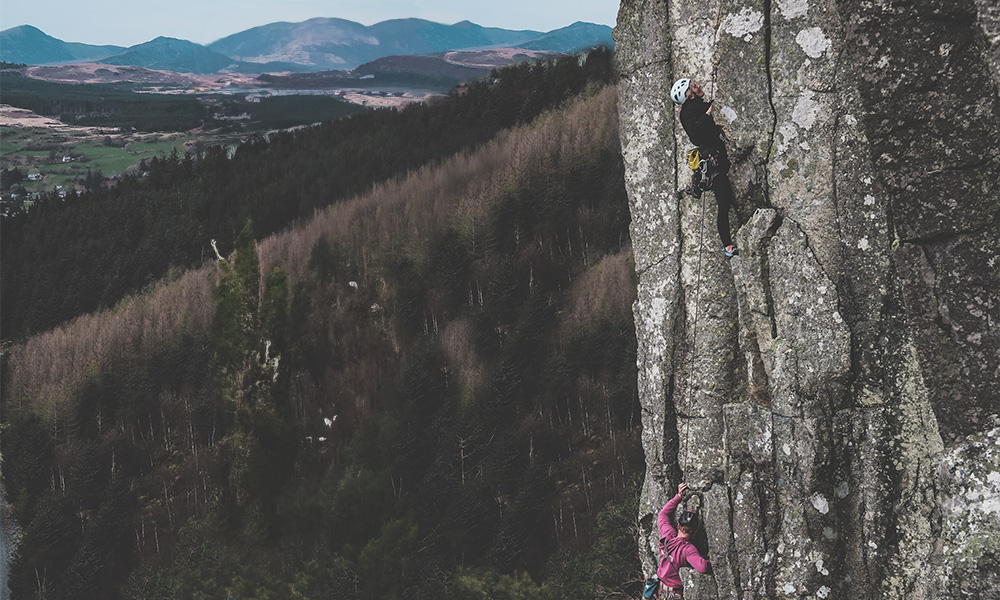 Climbers on the route Lightning Visit at Carreg Alltrem in North Wales