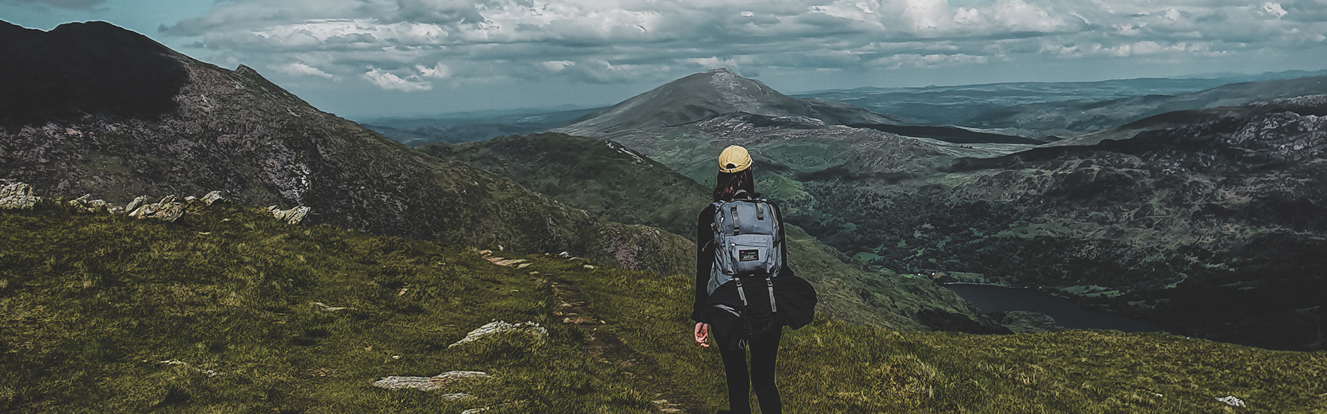 Woman walking in the mountains in Eryri National park in Wales.