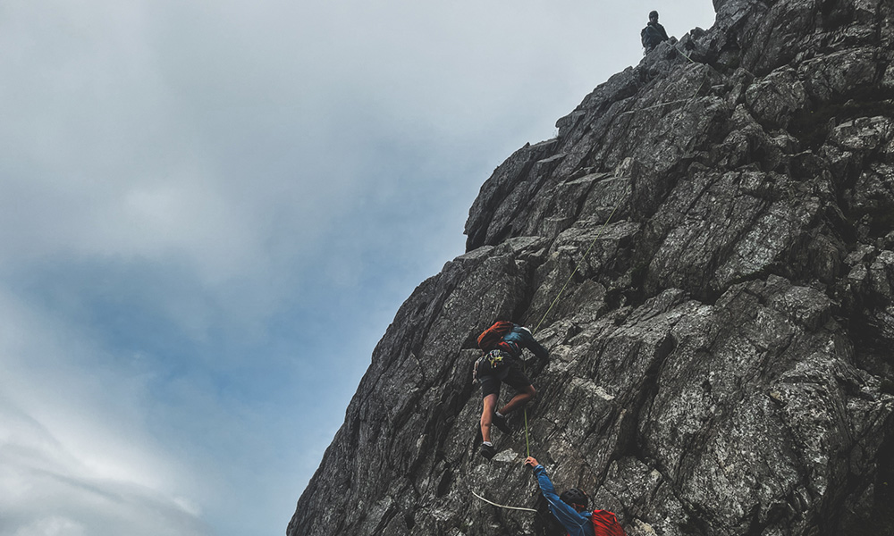 Two people getting guided on the sramble cneifion arete in North Wales, UK.