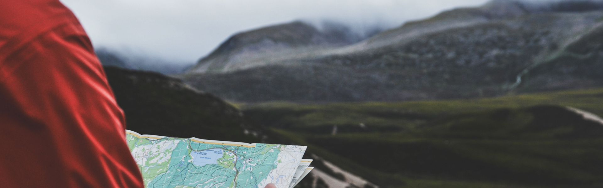 A person reading a map in the Cairngorm National Park in Scotland.