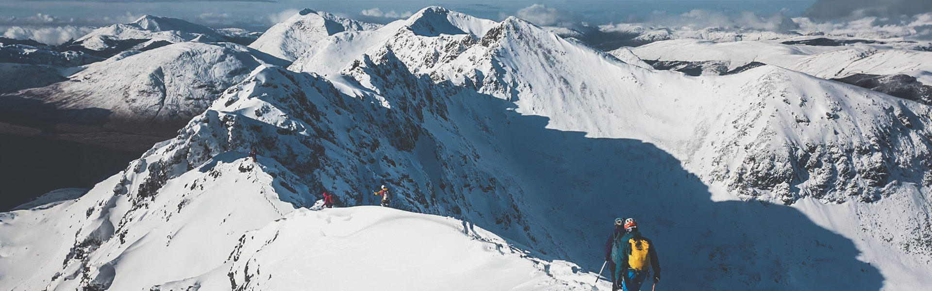 Walkers on the Aonach Eagach ridge in Scotland, UK.