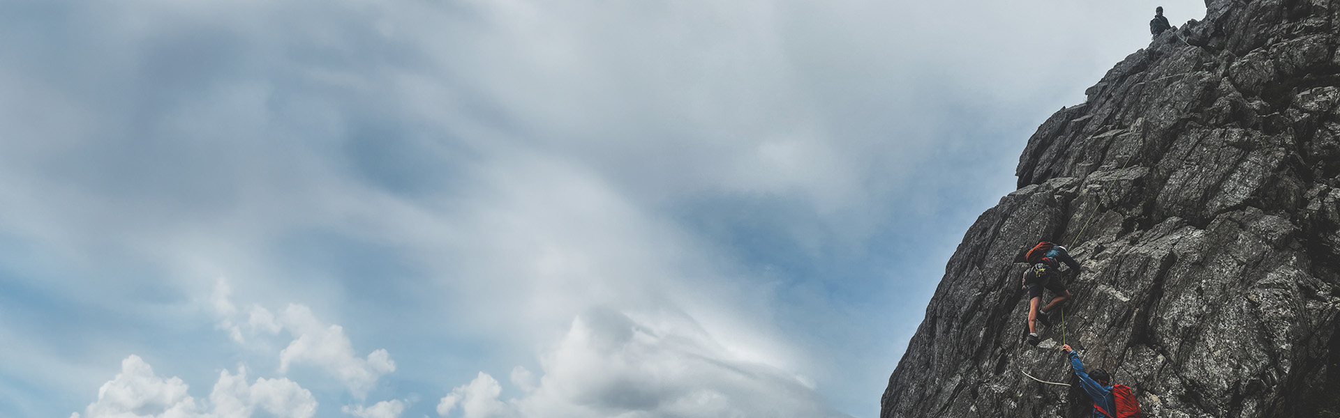 A group of climbers, scrambling on Cneifion Arete in North Wales.