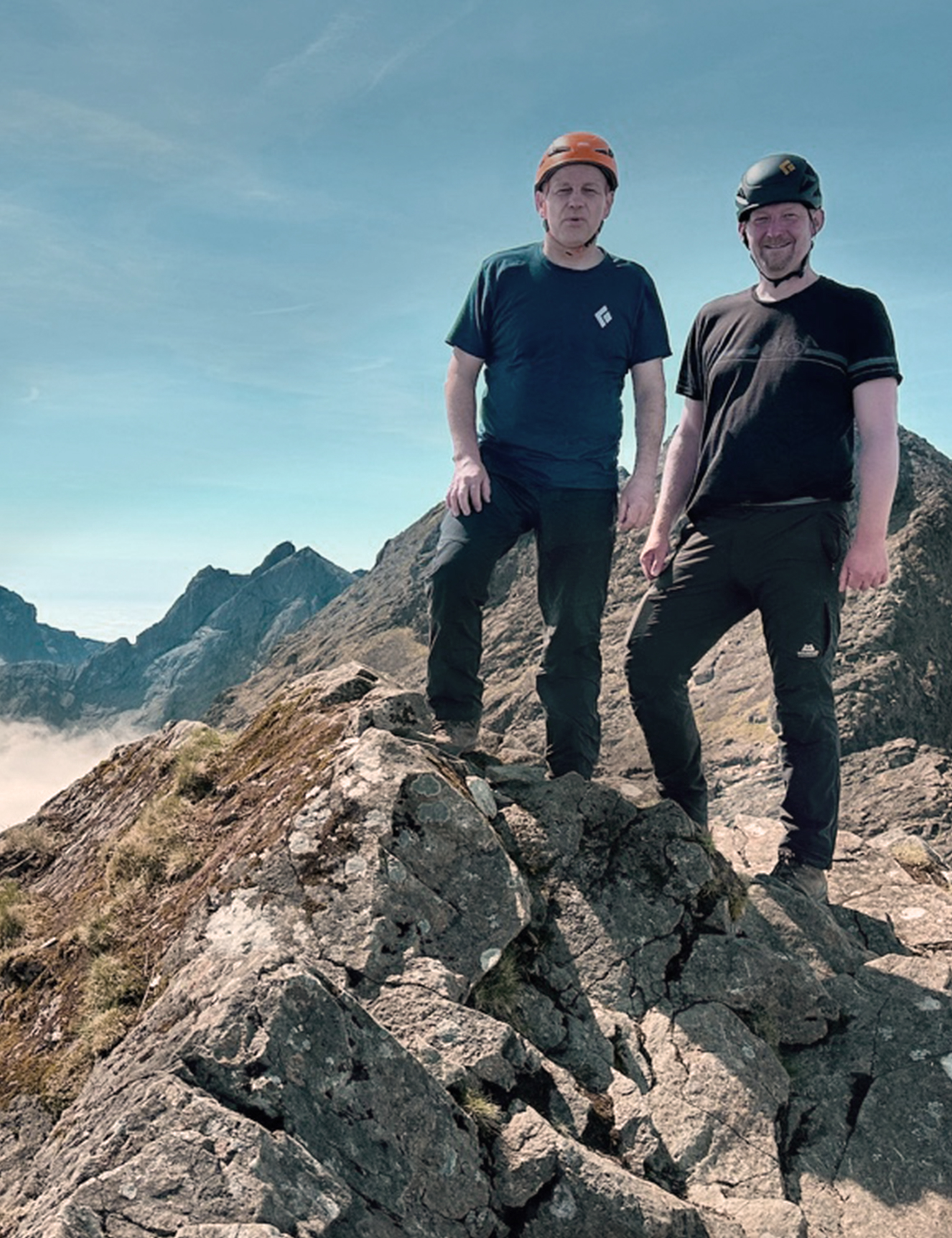 Two guys with helmets on the Cuillin Ridge on the Isle of Skye in Scotland completing the Munros.