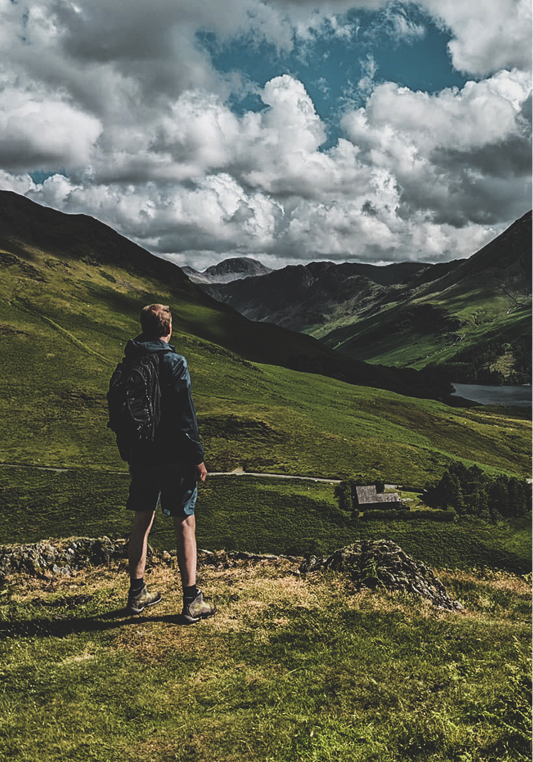 Guy looking in the distance, enjoying the mountain view in the Lake District.