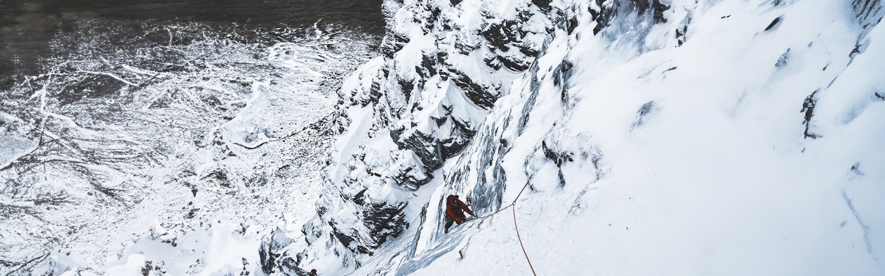 Person getting guided on a Winter Climbing route, Taxus in Scotland.