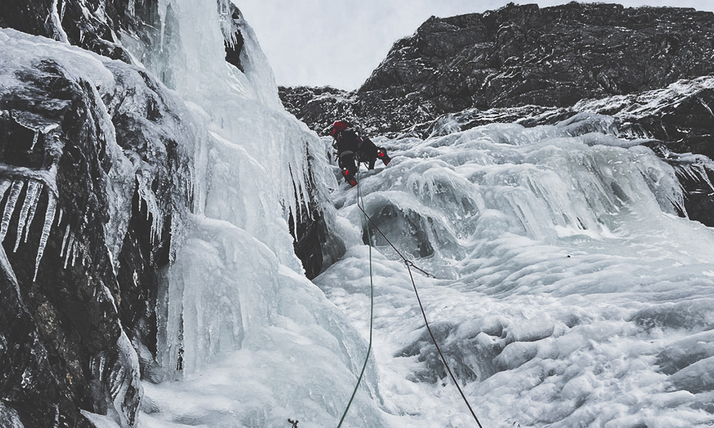 Climber on the route 'The Pumpkin' in Scotland Creag Meagaidh