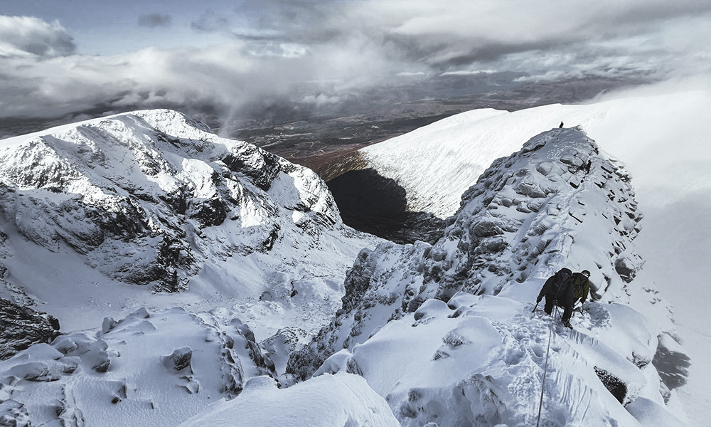 Two climbers getting guided on Tower Ridge in Scotland, Ben Nevis.