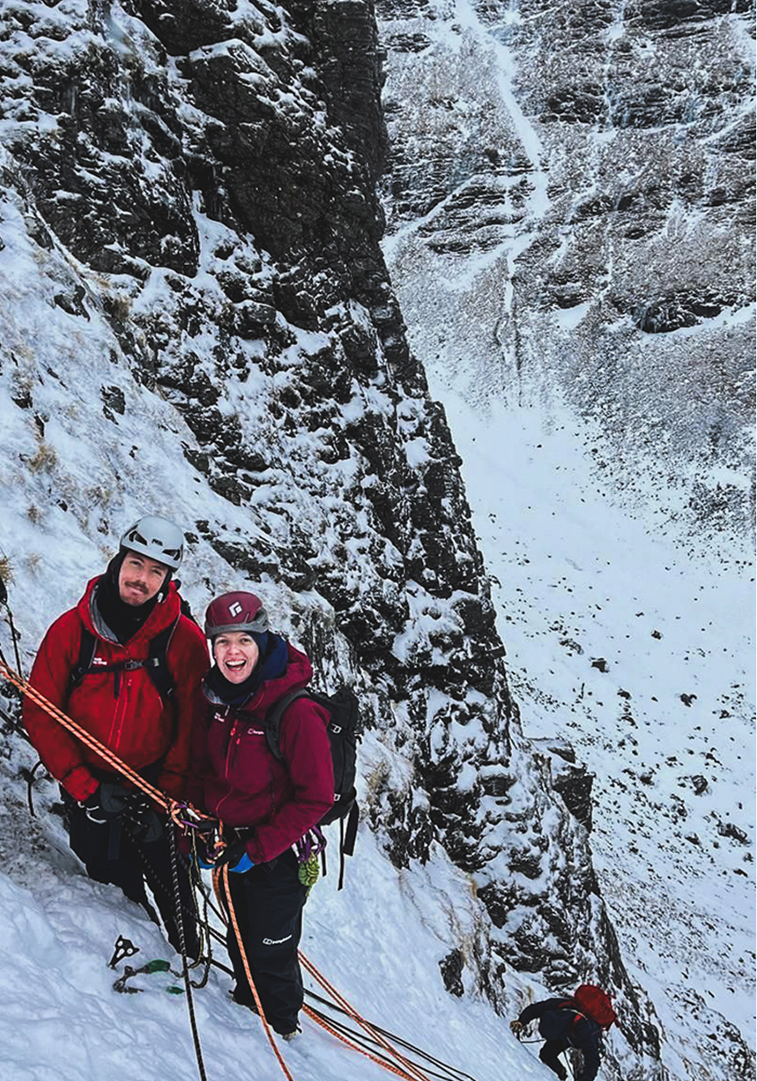 Two people getting guided on a winter climbing route at Creag Meagaidh, Scotland.